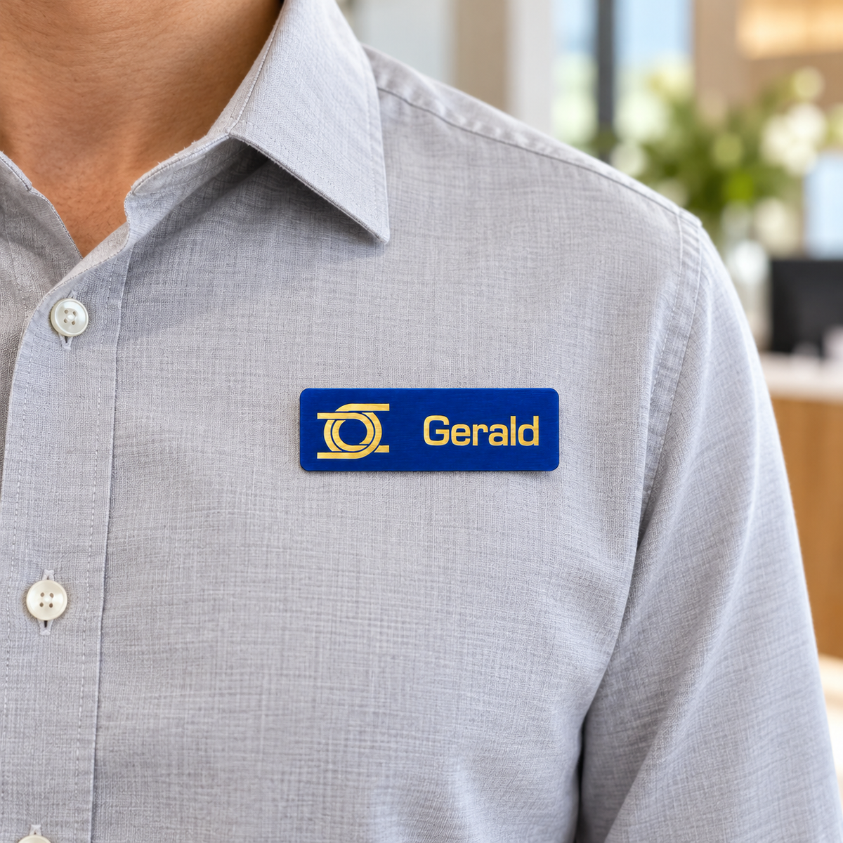 Engraved Metal Name Badge worn on clothing — lifestyle example