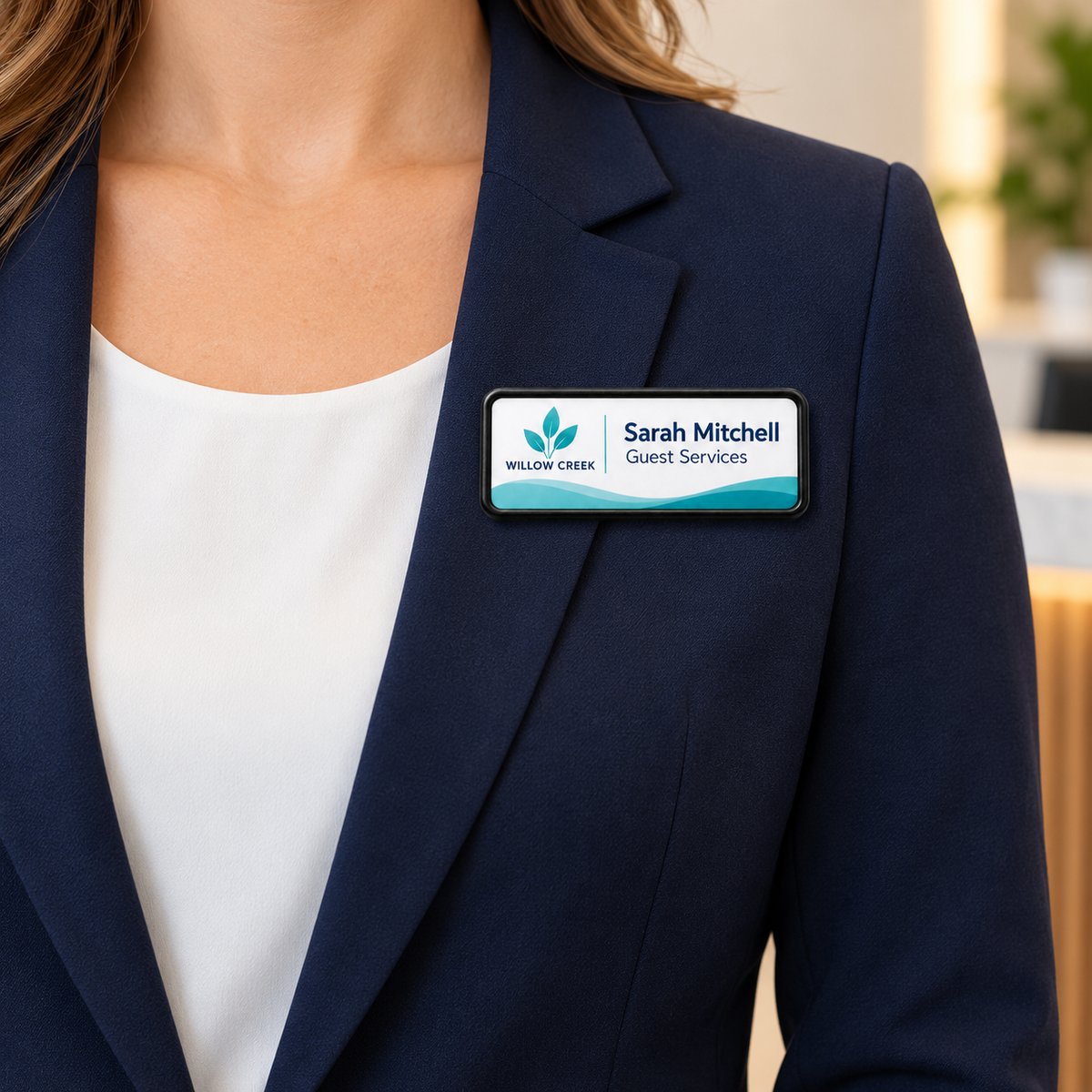 Framed full-color printed name badge worn on a navy blazer