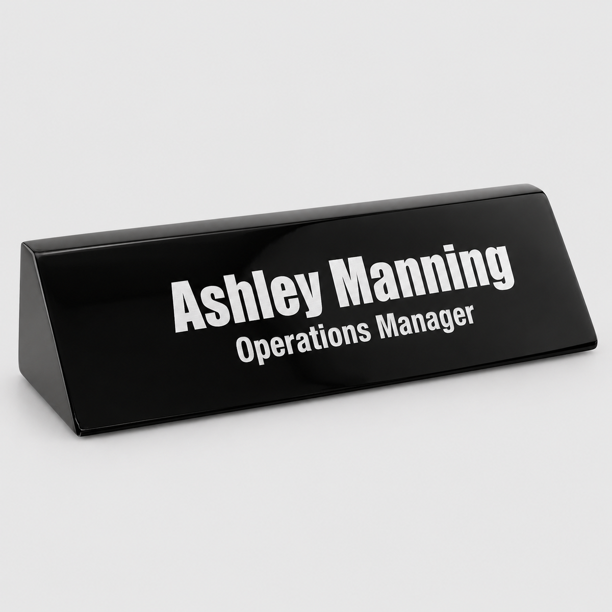 Black piano-finish desk wedge with direct silver-tone engraving
