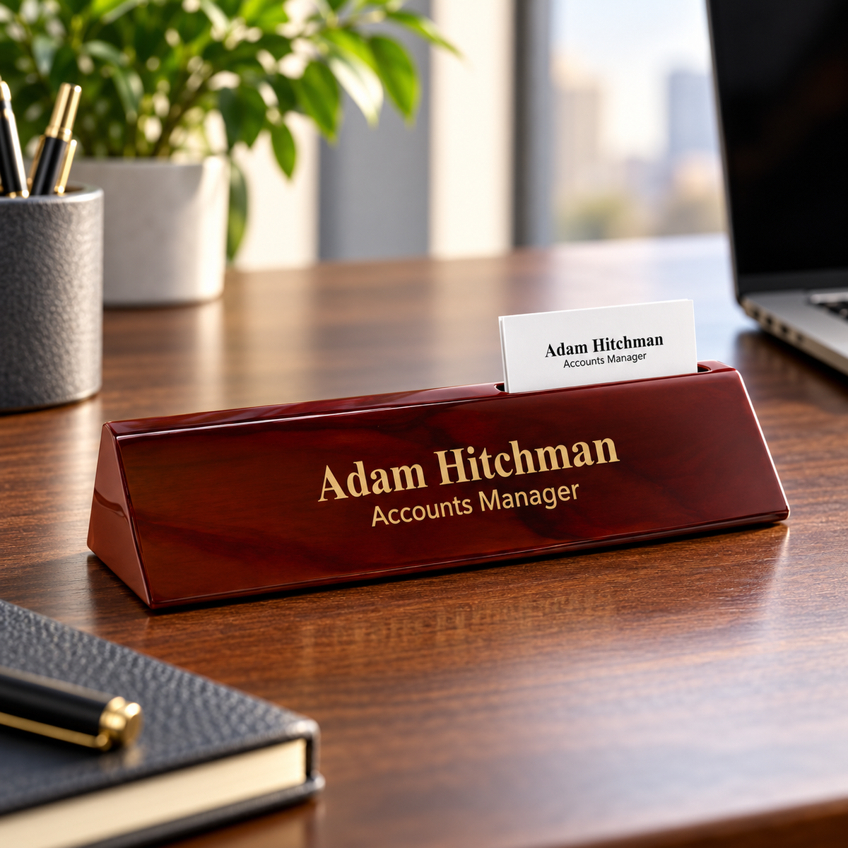 Direct-engraved rosewood desk wedge with card holder on an office desk