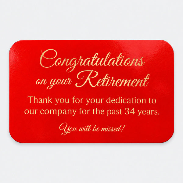 Red metal plate with gold retirement engraving and rounded corners.
