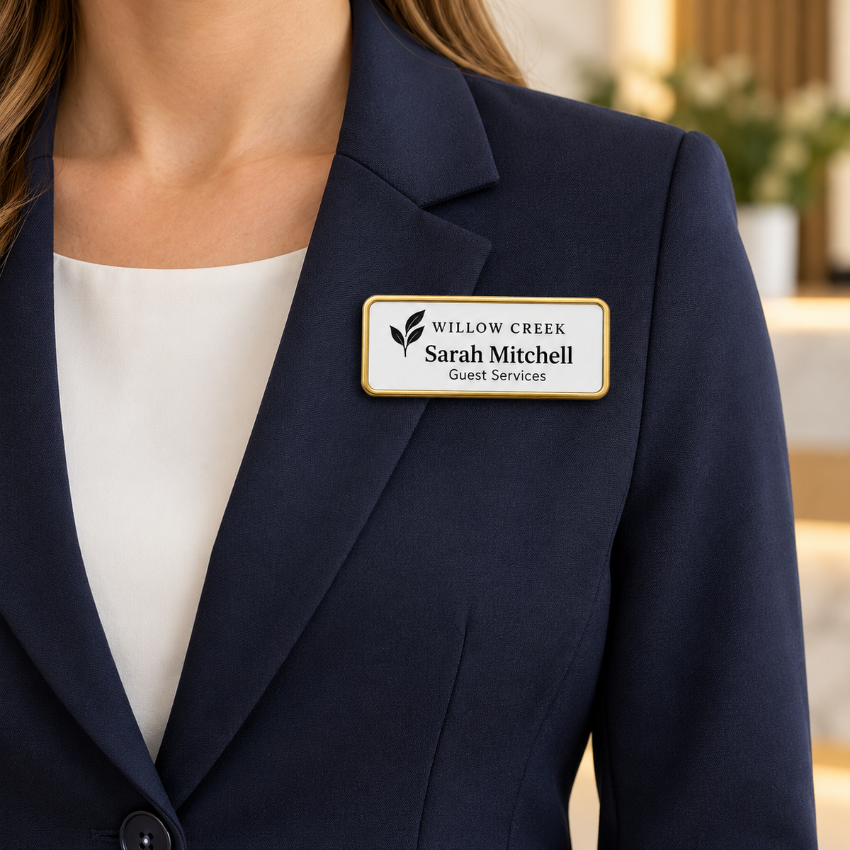 Framed engraved plastic name badge worn on a navy blazer
